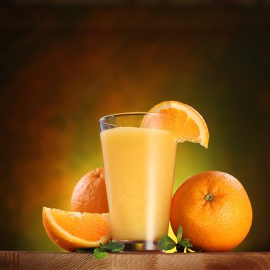 Oranges and glass of juice.
