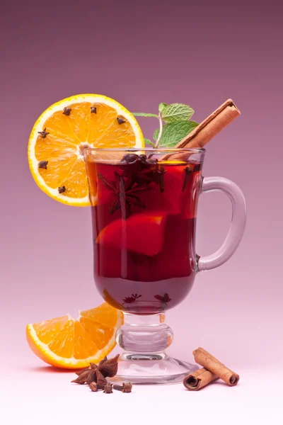 stock image Glass of mulled wine on a pink background