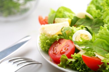 Salad with tomatoes and quail egg clipart