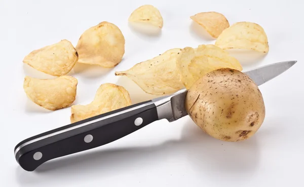 stock image Conceptual image - the knife cuts fresh potatoes and potato chip