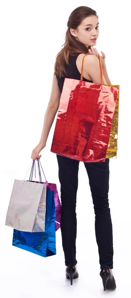 Beyaz arka planda alışveriş torbaları olan bir kız.. — Stok fotoğraf