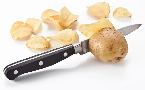 Conceptual image - the knife cuts fresh potatoes and potato chip Royalty Free Stock Photos