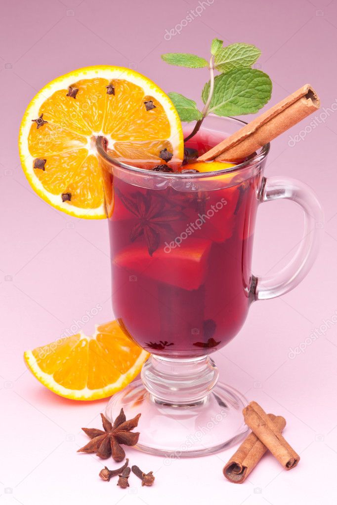 Glass of mulled wine on a pink background