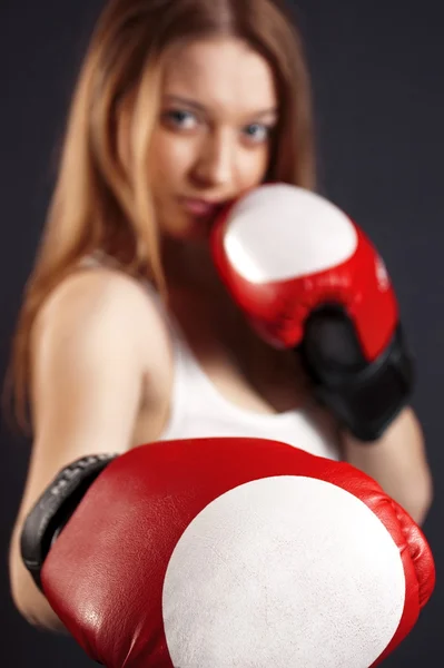 stock image A beautiful young girl is in boxing-gloves