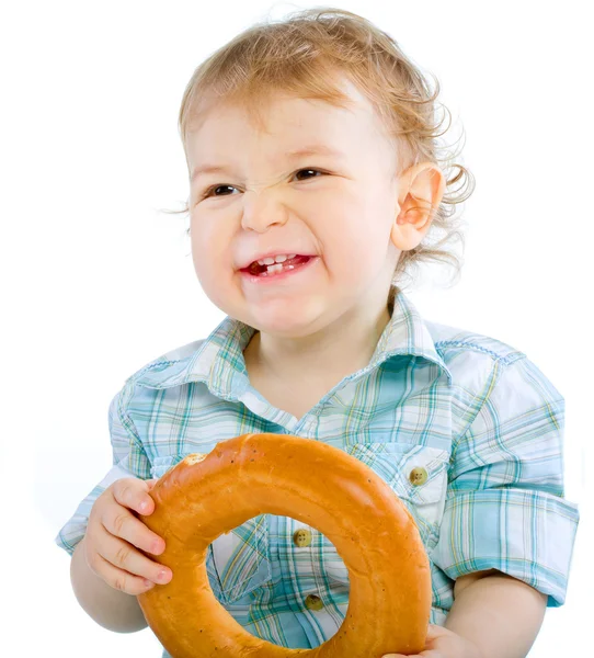 Little baby boy holding a bagel — Stock Photo, Image