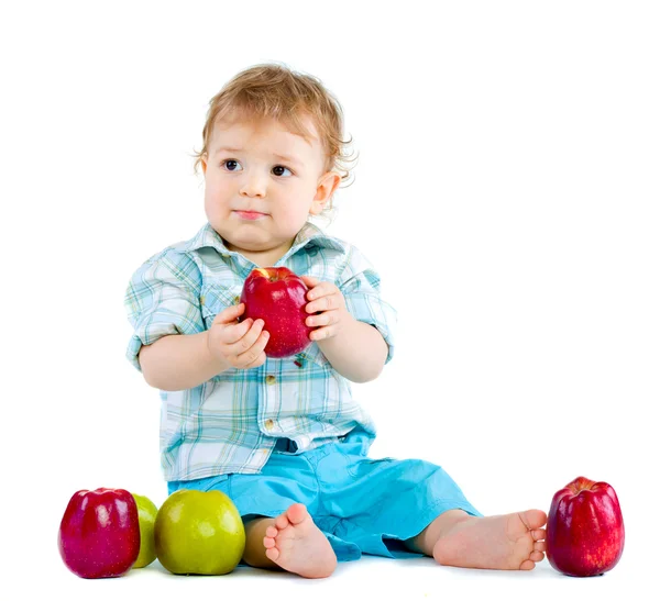 Beautiful baby boy eats red apple. — Stock Photo, Image