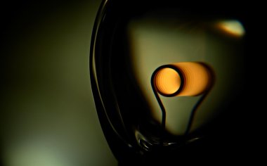 Glower is heated. Conceptual shot of incandescent lamp in green. clipart