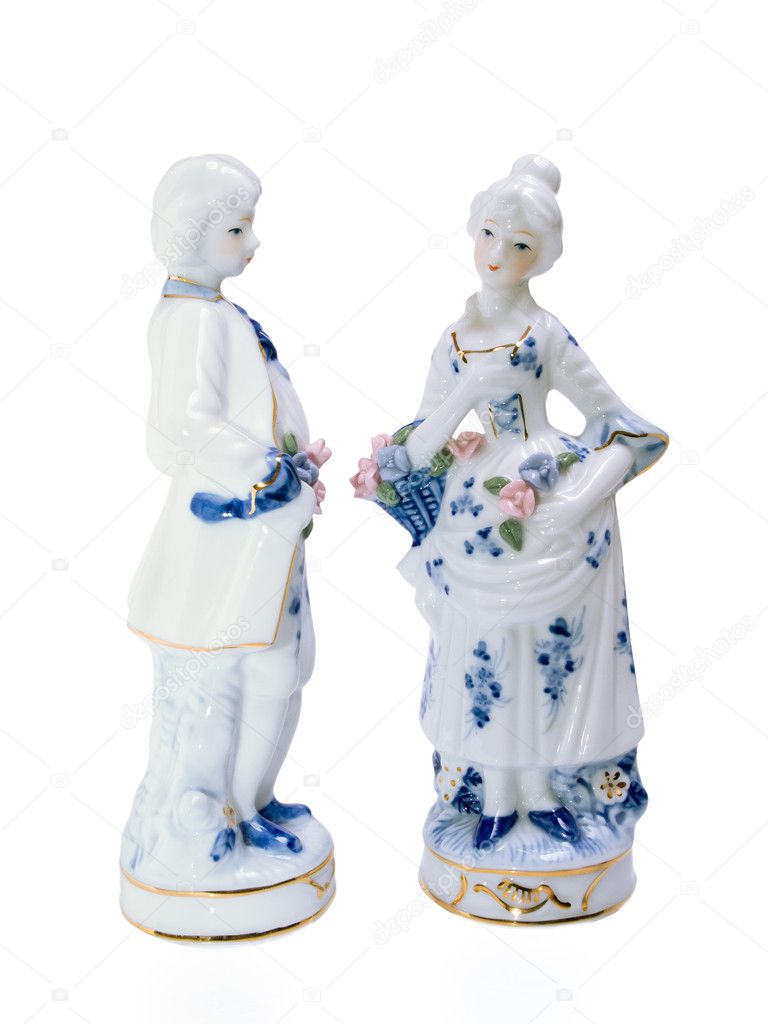 Porcelain figurines of young men and women arc turned to each other.
