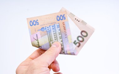 Hryvnia in mans hand clipart