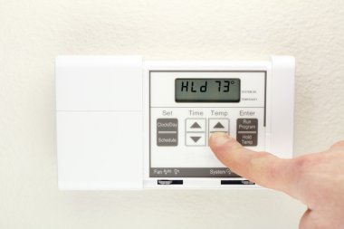 Hand on Thermostat clipart