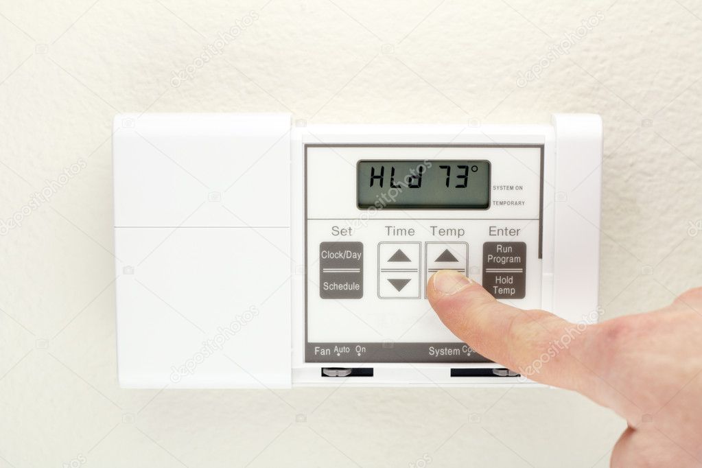 Hand on Thermostat