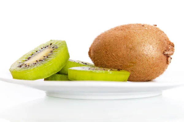 A plate with fresh kiwi isolated Royalty Free Stock Photos