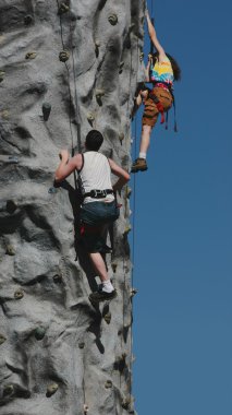 Fairground challenge, climbing the treadwall. clipart