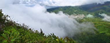 View of Saint Lucia from the cloud covered summit of the Petit Piton - Saint Lucia. clipart