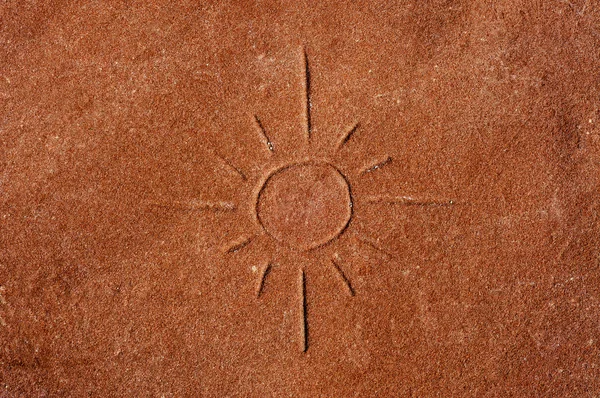 A sun carved on a red stone — Stock Photo, Image