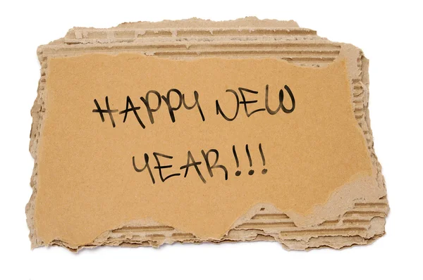 Feliz año nuevo escrito en un cartón marrón — Foto de Stock