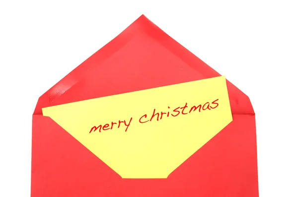 Merry christmas written on a yellow postcard inside a red envelope — Stock Photo, Image