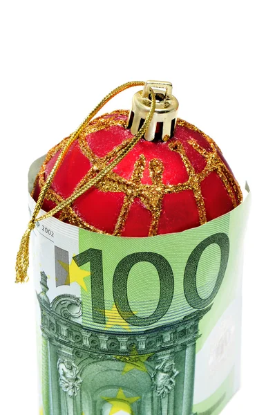 Різдвяний м'яч з євро рахунками символізує споживання — стокове фото