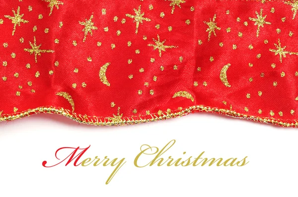 Feliz Navidad escrita en un fondo con un tejido con estampado de Navidad —  Fotos de Stock