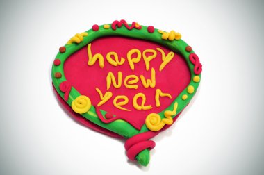 Happy new year written in a design made with modelling clay clipart