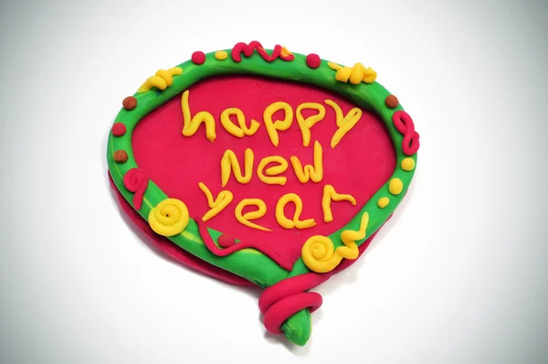 Feliz ano novo escrito em um design feito com argila modelagem — Fotografia de Stock