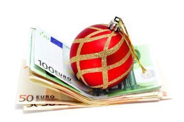 A christmas ball with euro bills symbolizing consumerism clipart