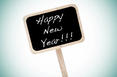 Happy new year written in a blackboard label clipart