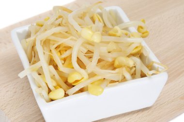 A bowl with soybean sprouts isolated on a white background clipart