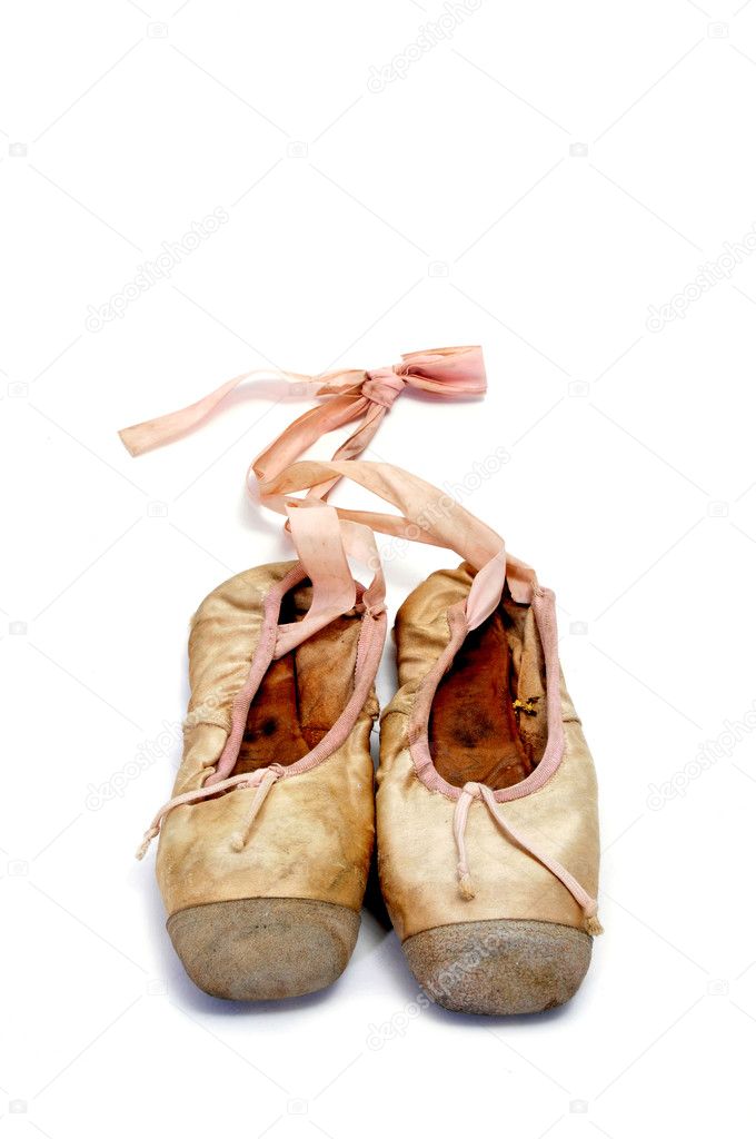 A pair of old pointe shoes isolated on a white background