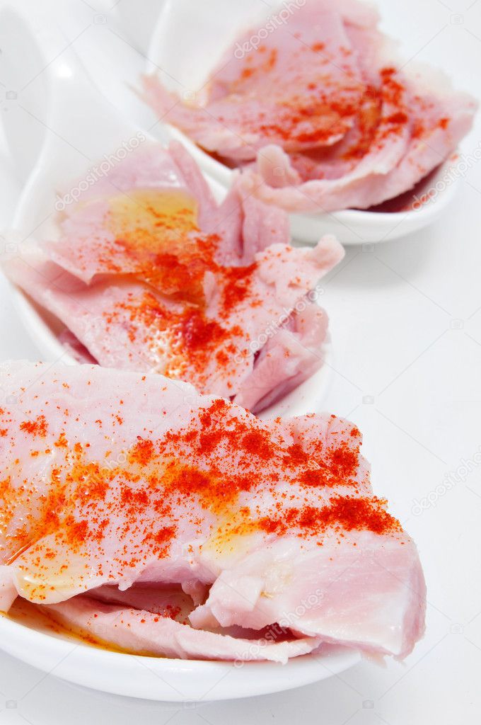 Some slices of lacon, typical ham of Spain, with paprika
