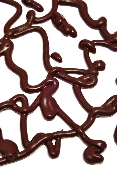 Çikolata Şurubu Izlemeler Üzerinde Beyaz Bir Arka Plan — Stok fotoğraf