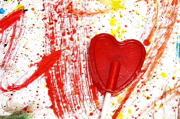 Una Piruleta Forma Corazón Sobre Fondo Salpicado Muchos Colores — Foto de Stock