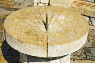 Closeup to an old stone sundial clipart