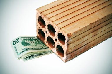 Money inside a brick symbolizing the mortgage crisis clipart