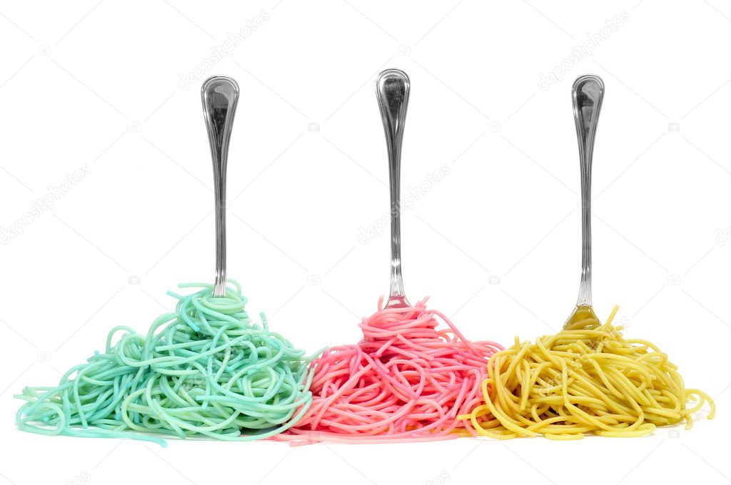 Some vegetable spaghetti rolled in forks isolated on a white background