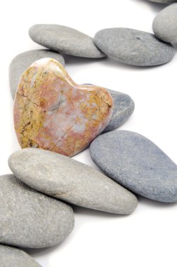 Zen stones, one heart shapped, on a white background clipart