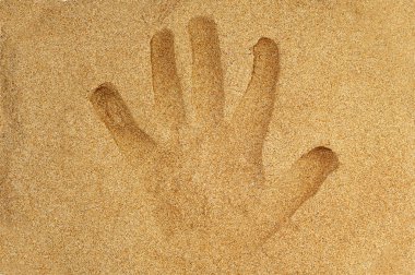 Handprint in the sand of a beach clipart