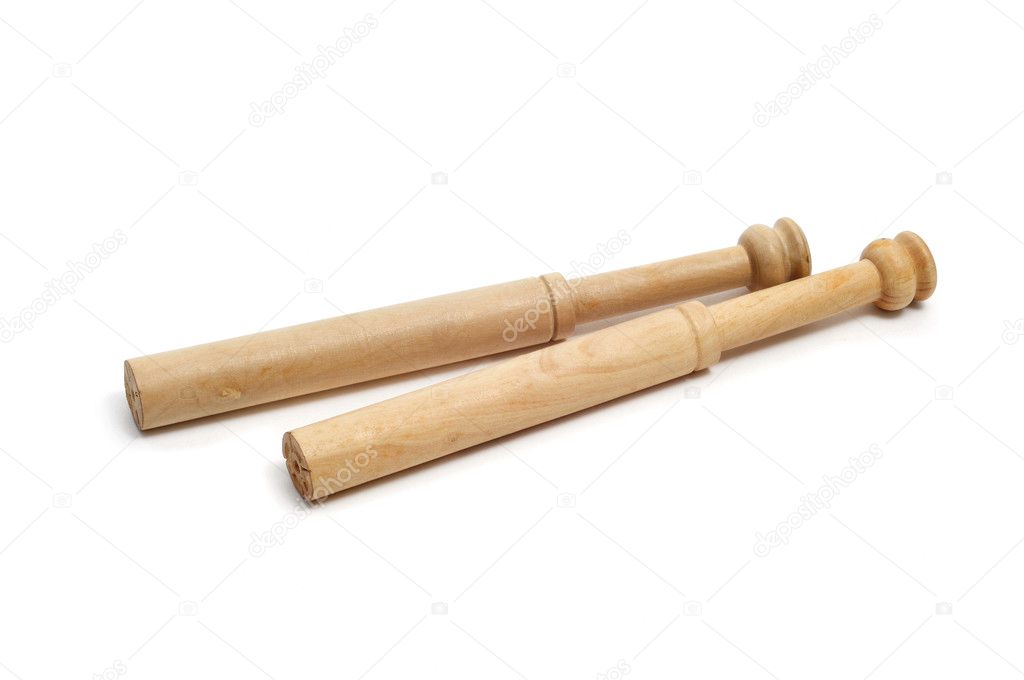 A pair of wooden bobbins for bobbin lace on a white background