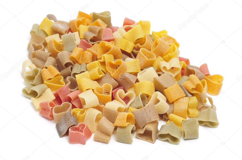 A pile of uncooked vegetables heart shaped pasta