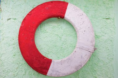 Old lifebuoy on a wall clipart