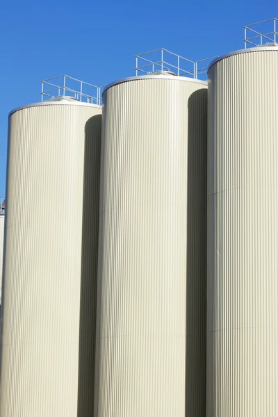 stock image Refinery oil storage tanks and blue sky in background