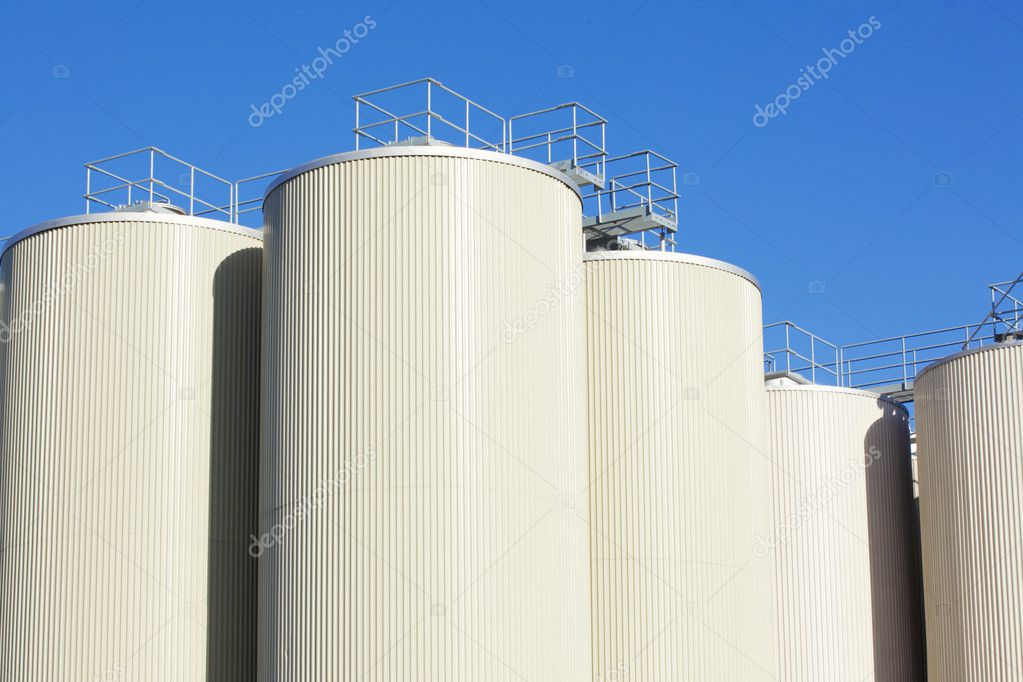 Refinery oil storage tanks and blue sky in background