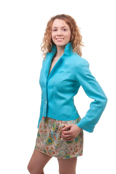 Jovem mulher bonita vestida de casaco azul e saia colorida — Fotografia de Stock