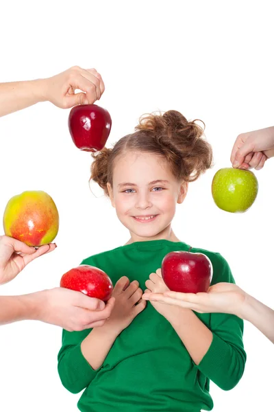 Beautiful smiling girl choosing among proposed apples — Stock Photo, Image
