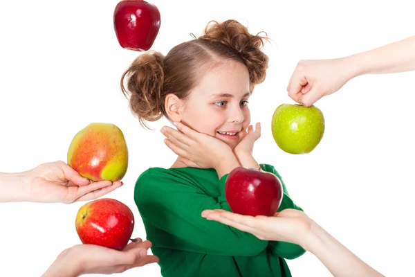 Surprised smiling girl choosing among proposed apples — Stock Photo, Image