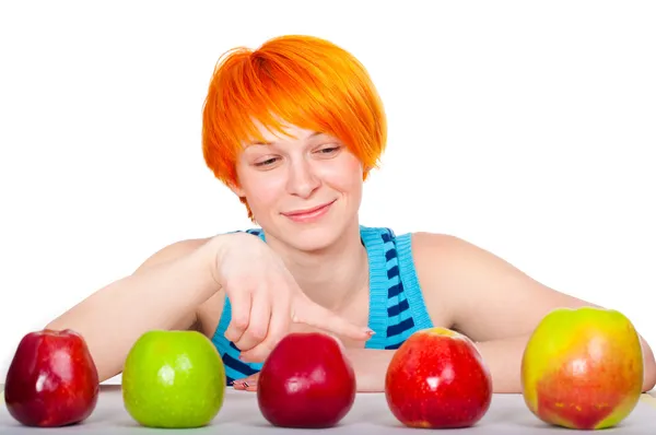 Smiling red hair woman choosing apple — Stock Photo, Image