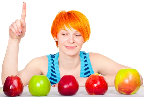 Smiling cute red hair woman choosing apple — Stock Photo, Image