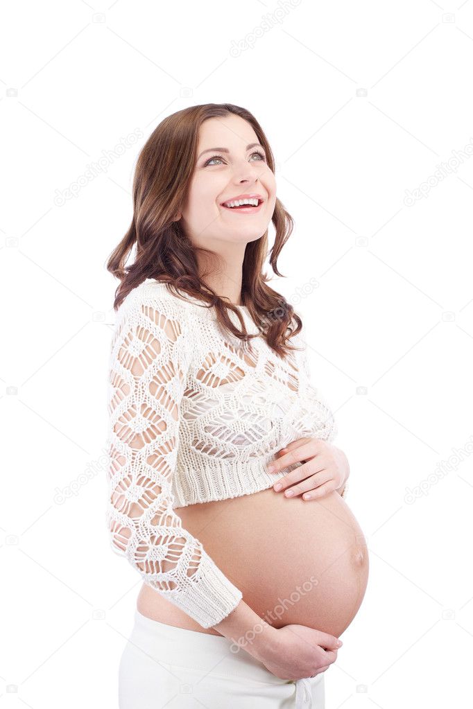Pregnant happy smiling woman holding belly looking up