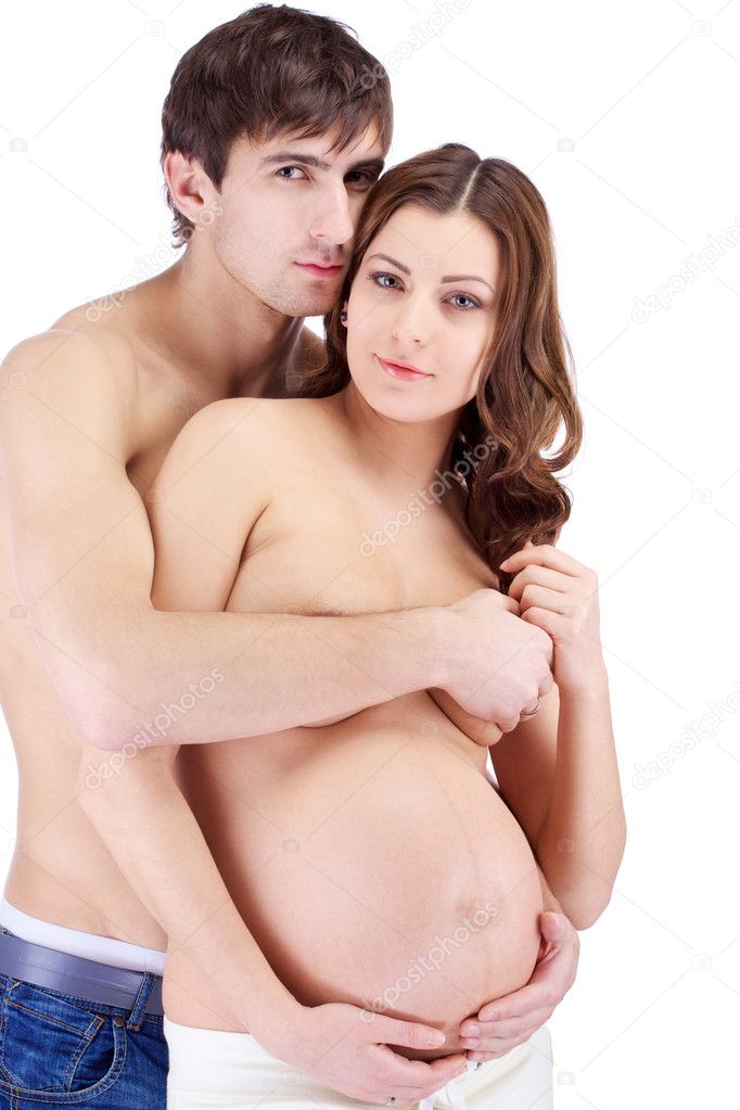 Happy smiling couple embracing with pregnant belly