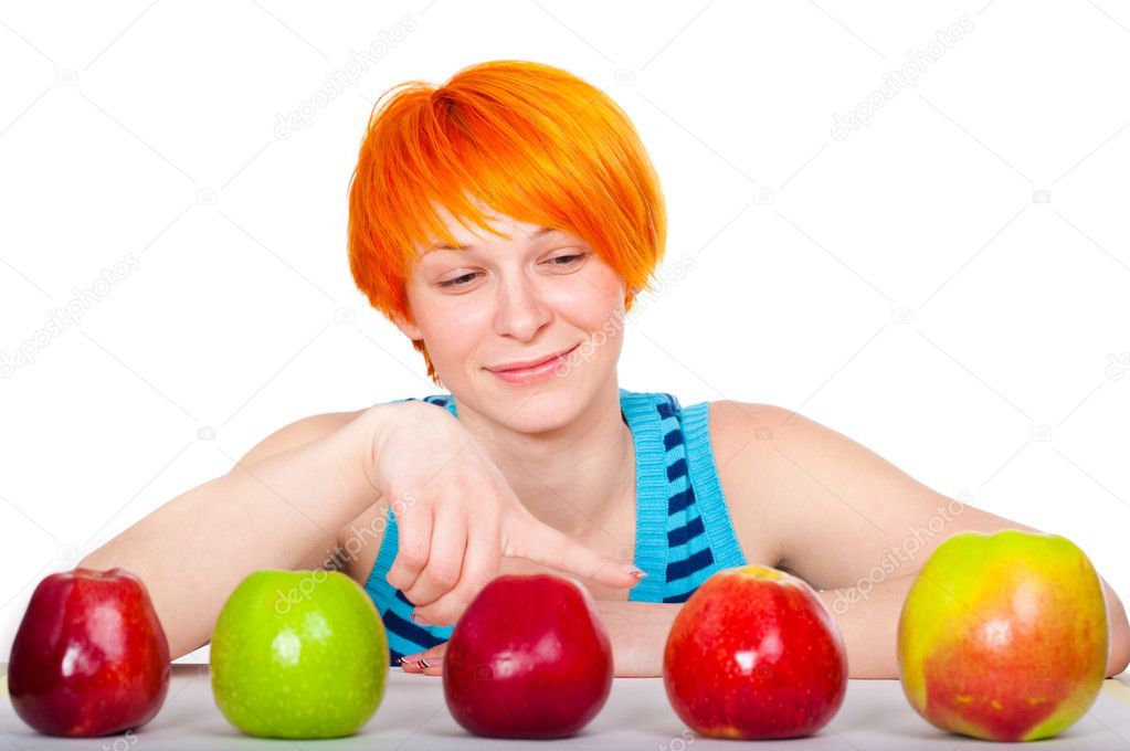 Smiling red hair woman choosing apple